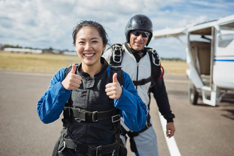 Ground photo of a tandem skydiver