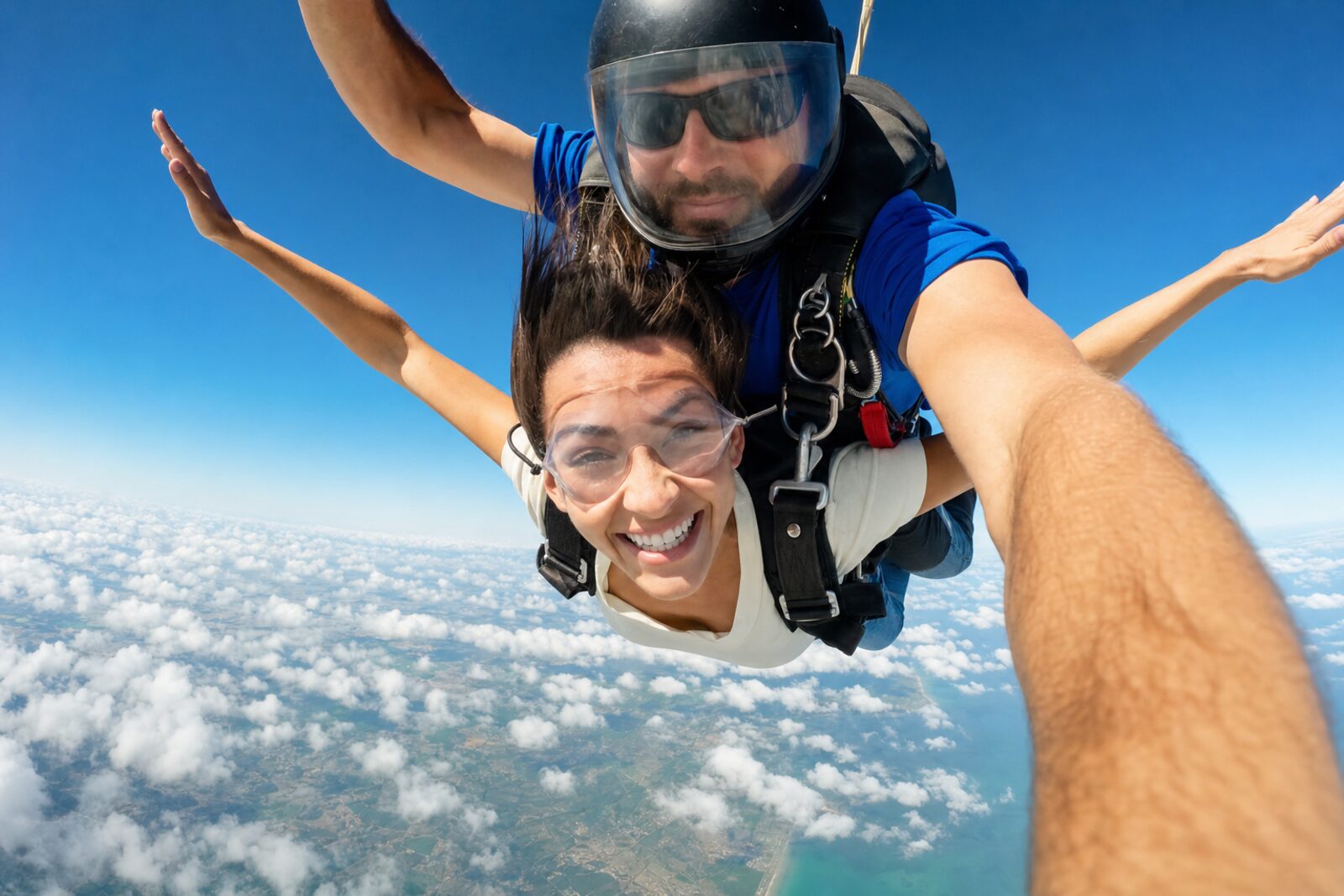 Hand-camera shot of a tandem skydiver in freefall